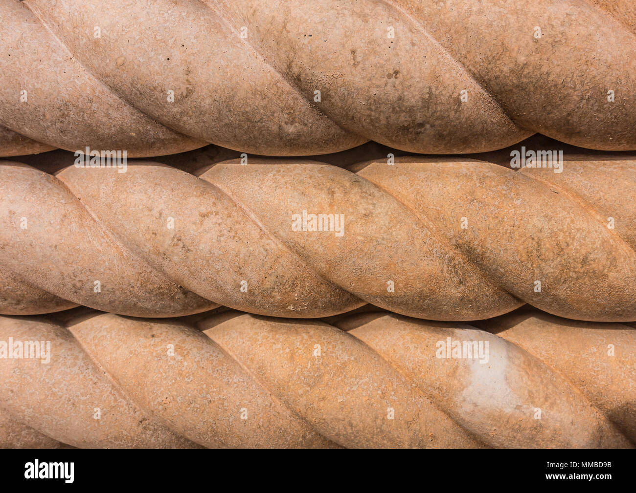 A macro shot of the rope twist detail of some terracotta path edging