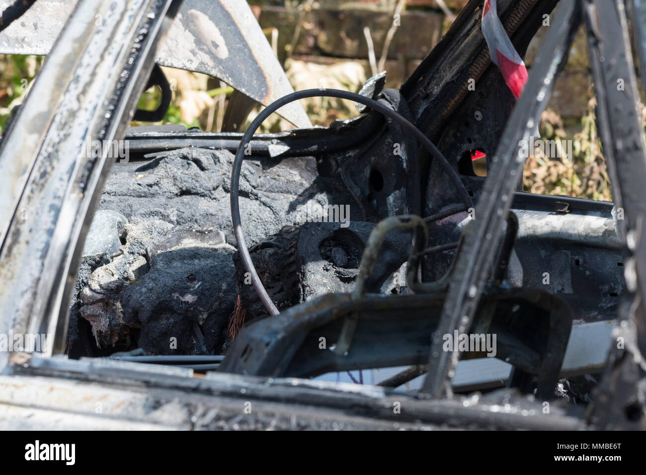 Burned out abandoned car after a fire, in the UK. Burnt out car. Auto fire. Stock Photo
