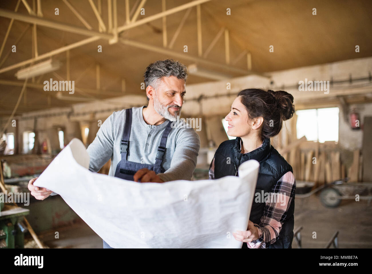 Man and woman workers in the carpentry workshop Stock Photo - Alamy