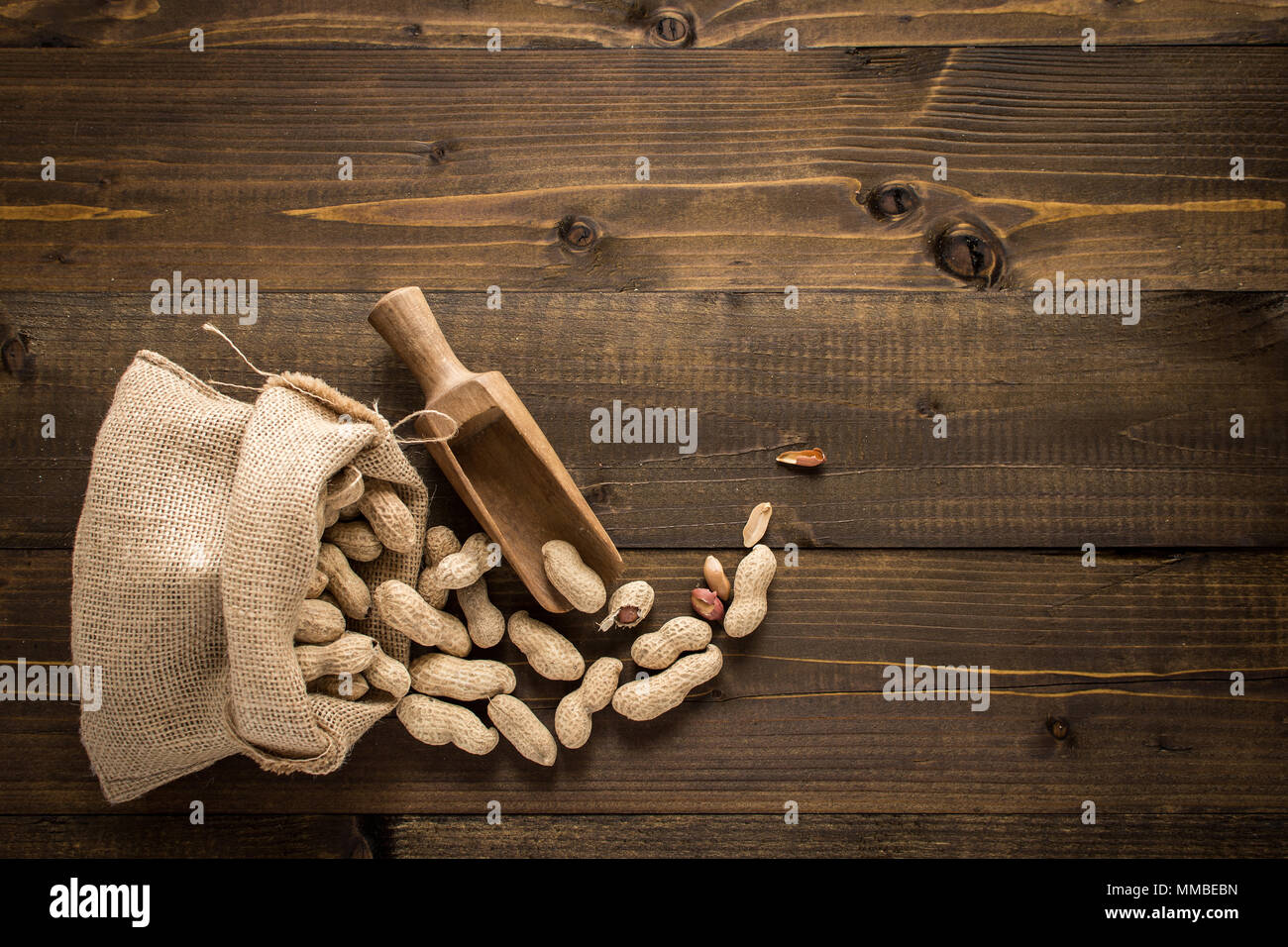 Organic Peanuts in Shells on Wooden Background. Copy Space. Stock Photo