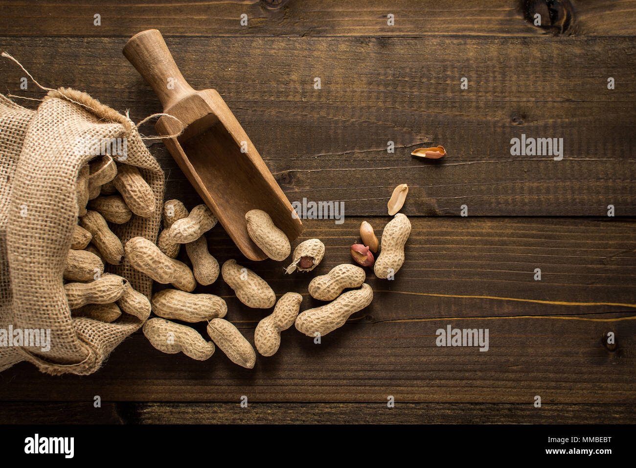 Organic Peanuts in Shells on Wooden Background. Copy Space. Stock Photo