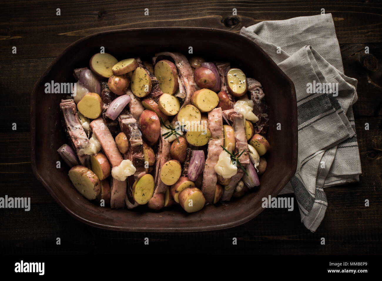 Lamb Loin Chops with Vegetables in Rustic Clay Dish Prepared for