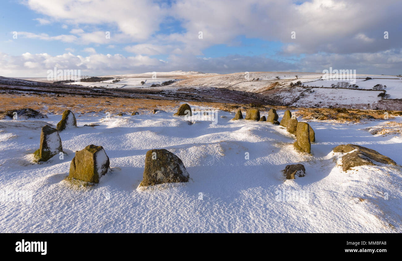 A snowy panoramic image of Nine Maidens Stone Circle on Dartmoor with High Wilhays in the background Stock Photo