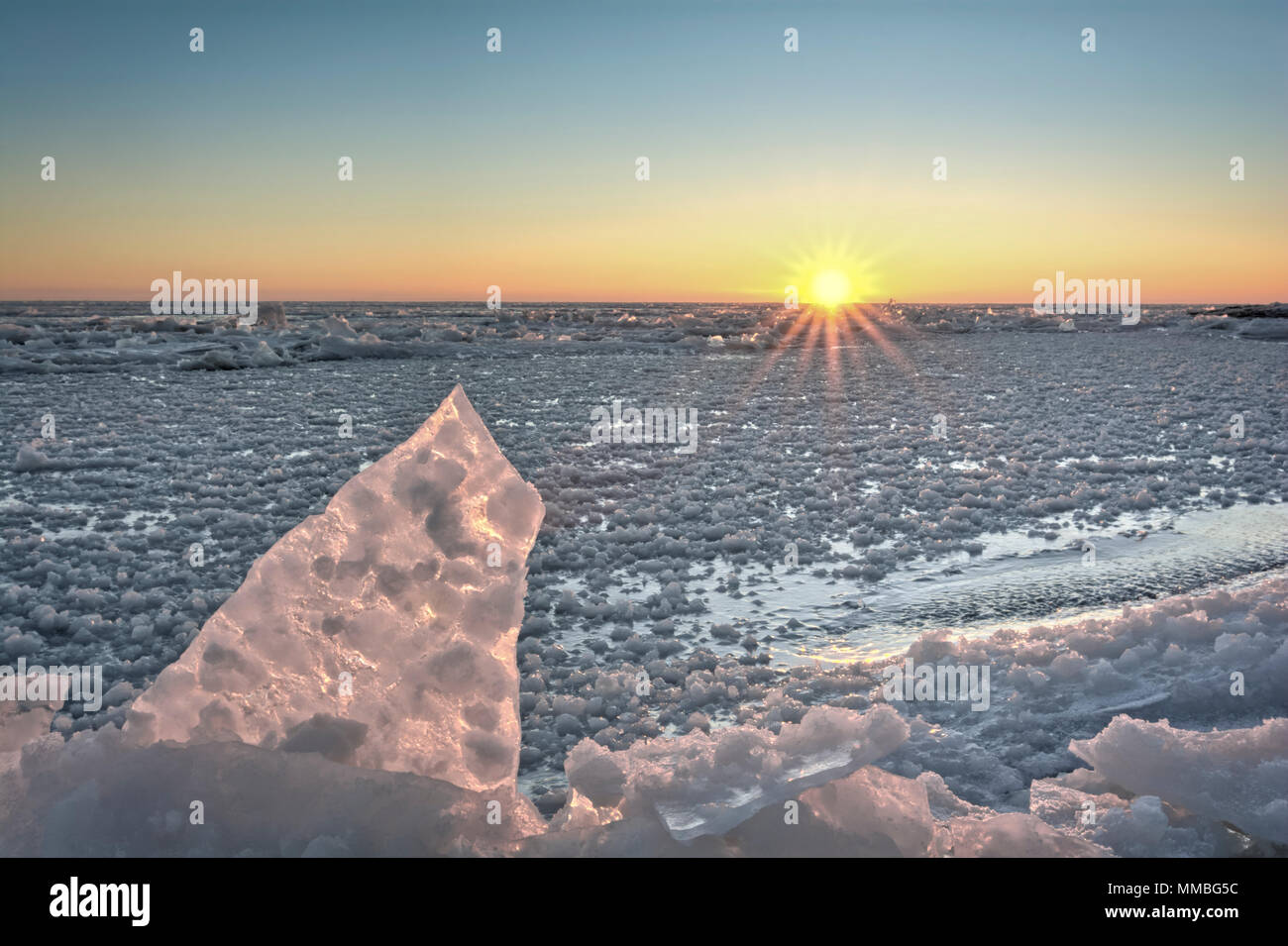 Lake Erie sunrise. Seen here in winter frozen with chunks of broken ice. Stock Photo