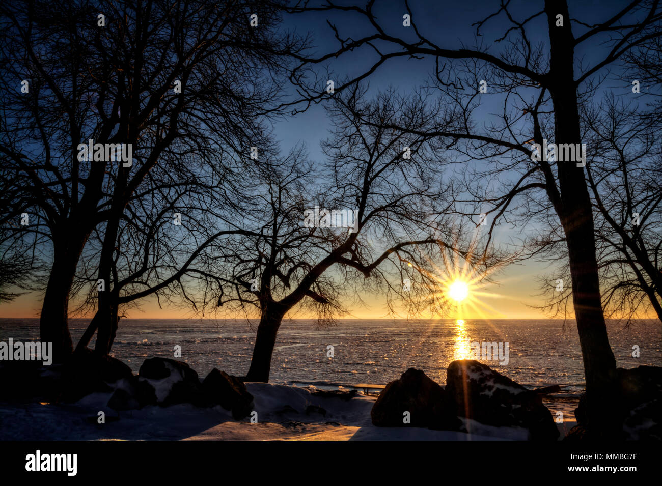 Winter sunrise along the snow covered rocky shore of Lake Erie In Northwest Ohio. Stock Photo