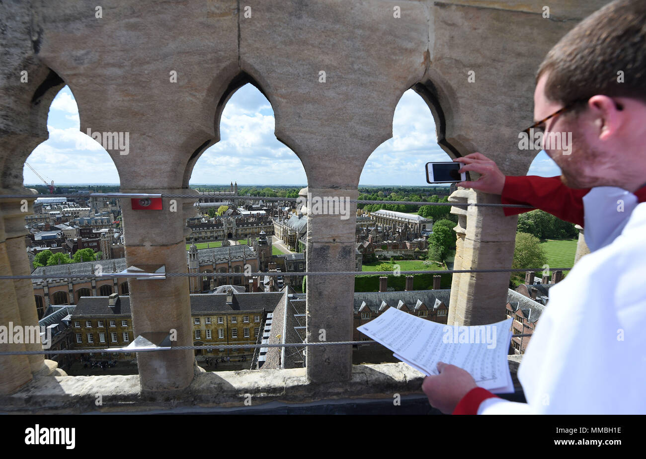 Chorister Piers takes a photo before the Choir of St John's College, Cambridge, perform the Ascension Day carol from the top of the Chapel Tower at St John's College, a custom dating back to 1902. Stock Photo