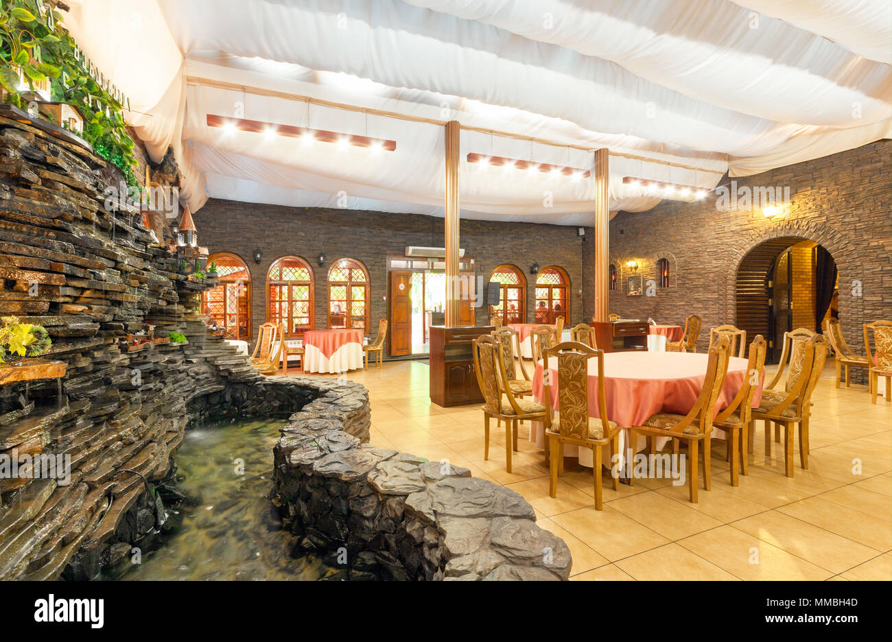 MOSCOW - AUGUST 2014: Interior of the restaurant of Caucasian cuisine "Dukhan Shavo". Hall with an artificial waterfall Stock Photo