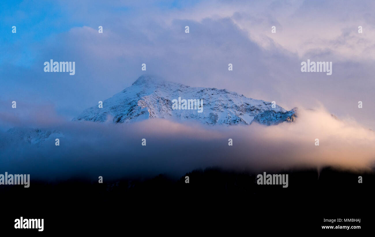 Snowy mountain shrouded in clouds hi-res stock photography and images ...