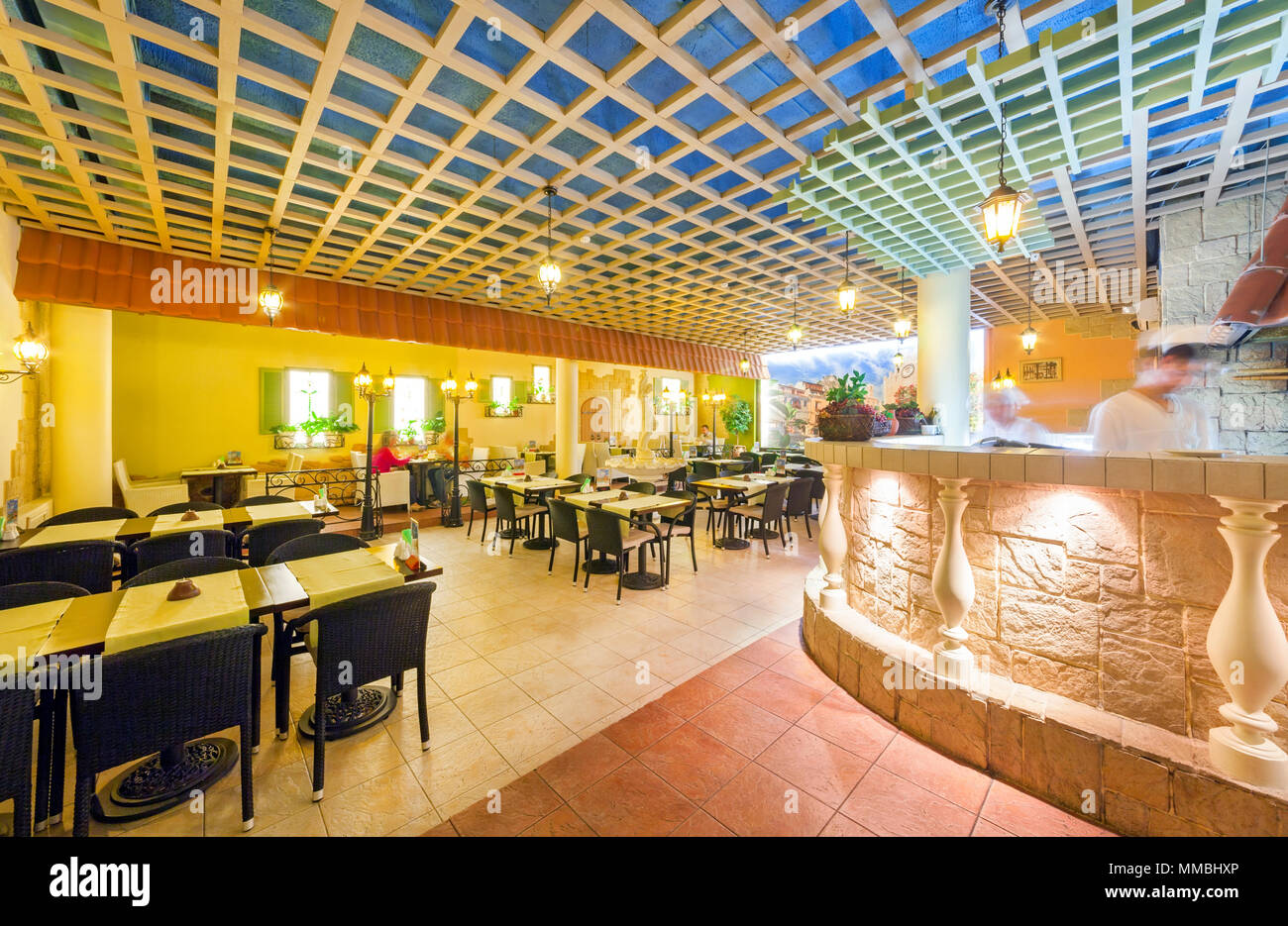 MOSCOW - AUGUST 2014: Interior of network inexpensive restaurant of Italian cuisine - 'DA PINO'. Hall with an open kitchen decorated for the old Itali Stock Photo