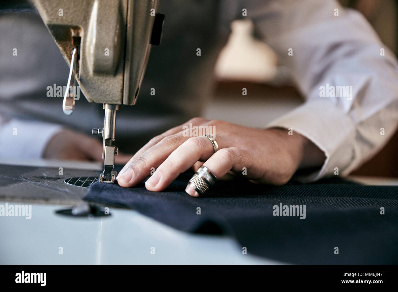 Man using an industrial sewing machine, stitching a garment Stock Photo Alamy