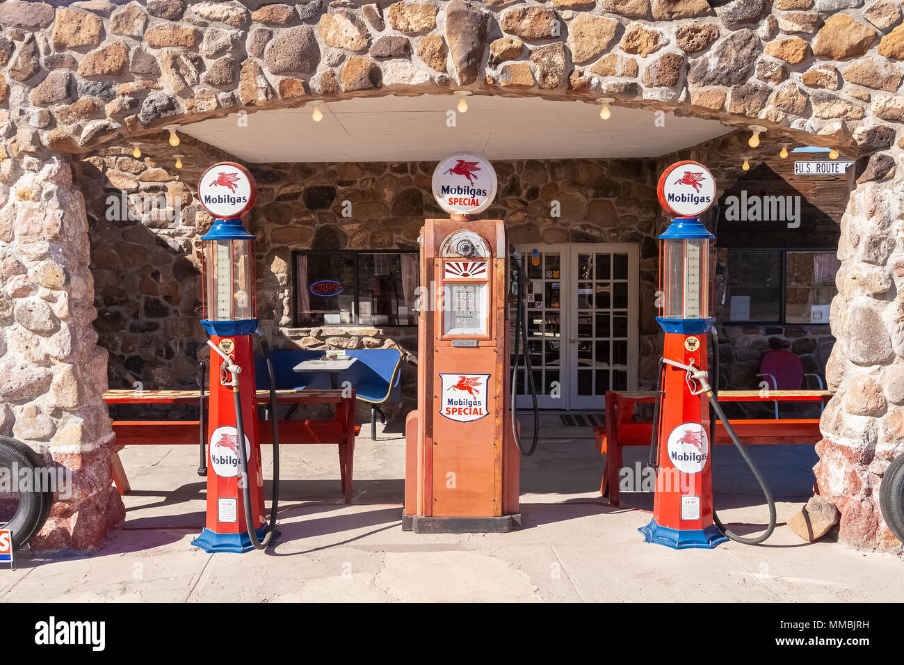 Old Mobilgas pumps displayed in front of a refurbished service station used as a snack and gift shop along the r Stock Photo