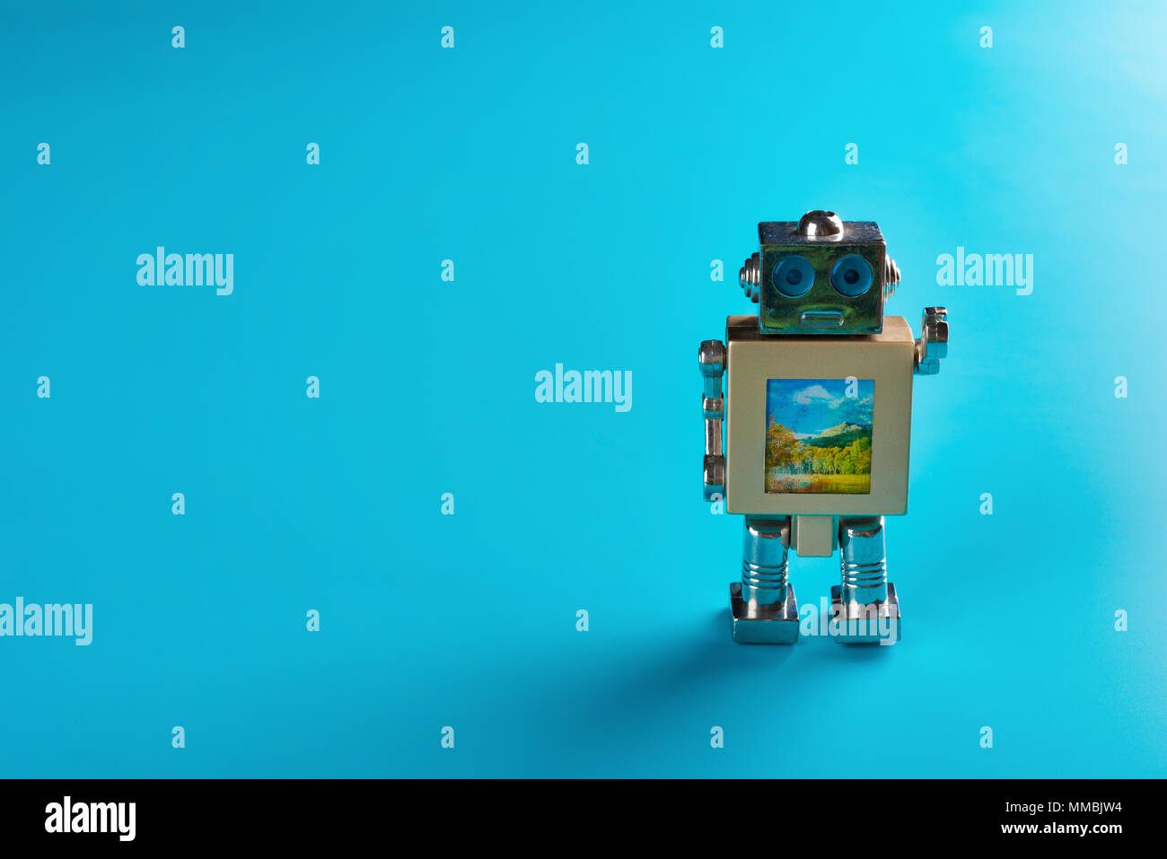 metal toy robot on a blue background Stock Photo