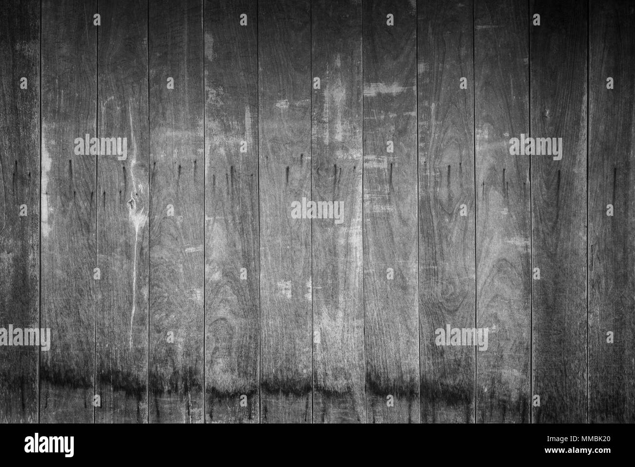 Full frame background of an old and faded wooden board wall with vignette in black and white Stock Photo