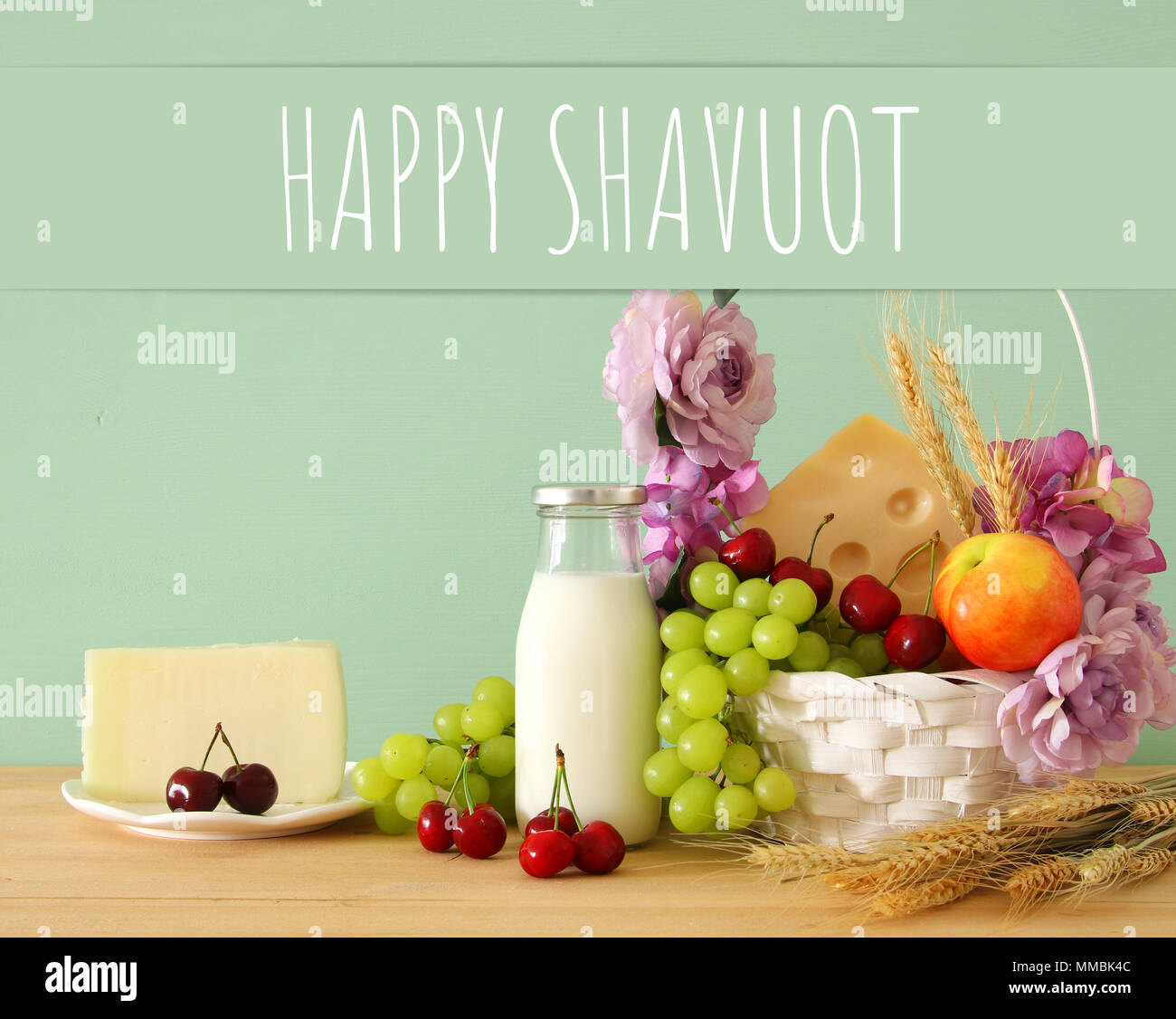 image of fruits and cheese in decorative basket with flowers over