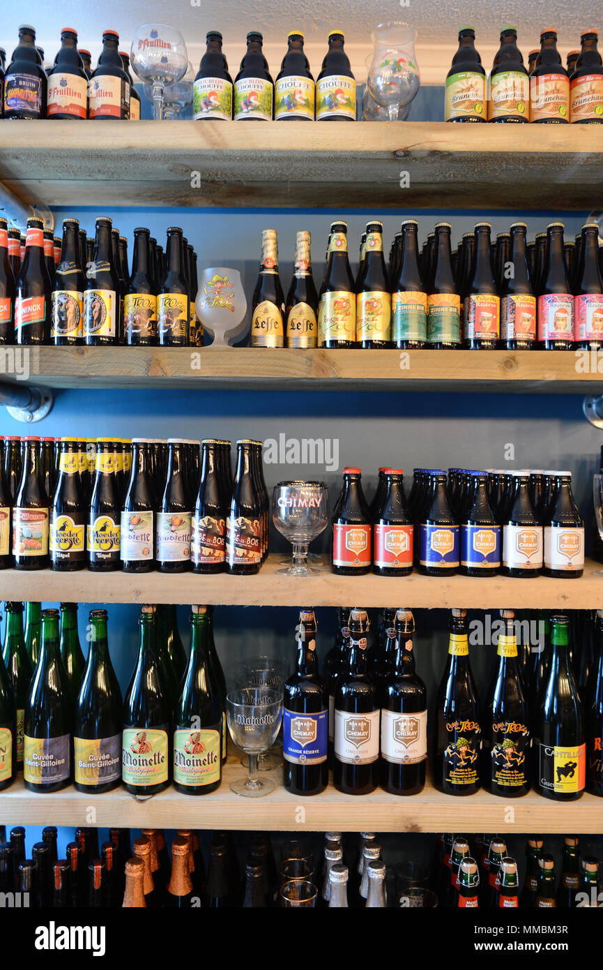 Inside a modern off license bottle shop with a variety of craft beers and unique brews and bottles with back lighting Stock Photo