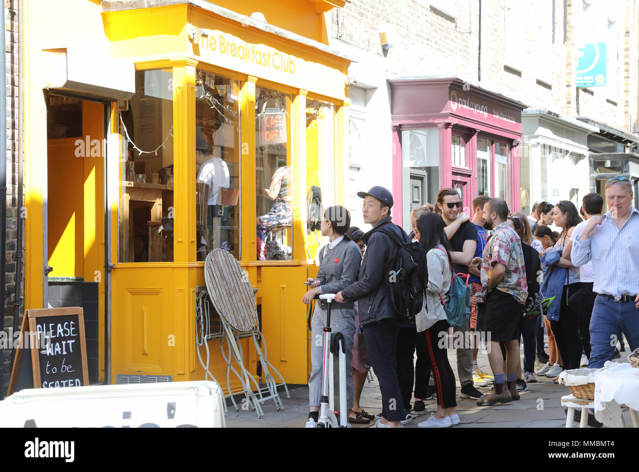 Queuing for the Breakfast Club on trendy Camden Passage off Upper Street in Islington, north London, UK Stock Photo