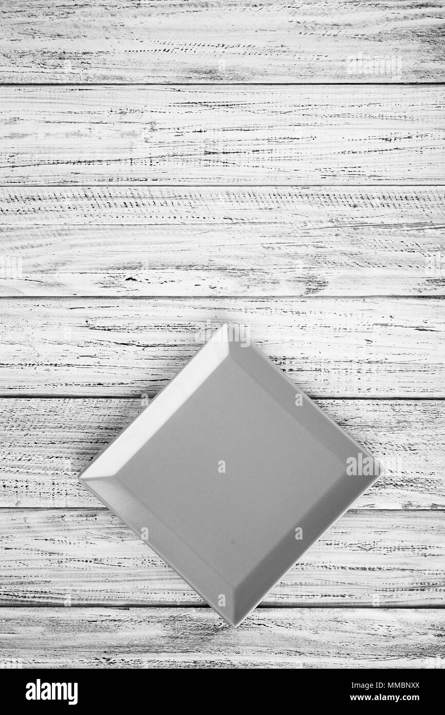 square plate on a wooden background Stock Photo