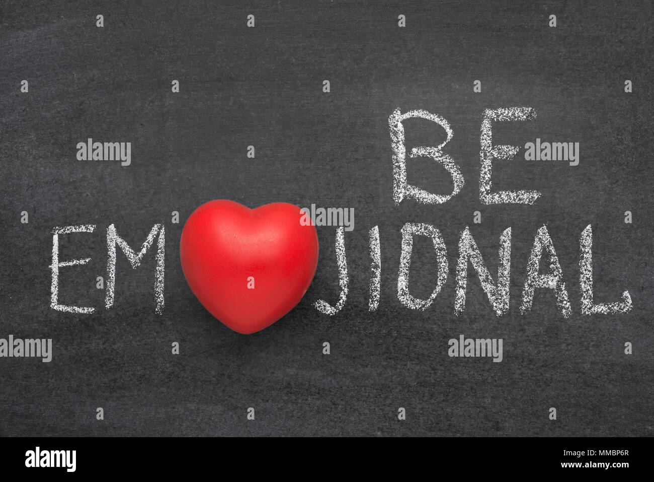 be emojional phrase handwritten on blackboard with heart symbol instead of O Stock Photo
