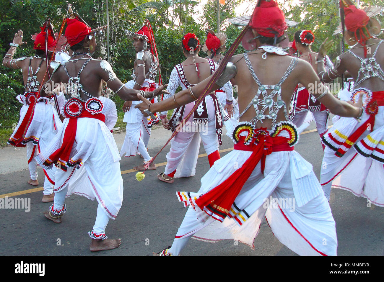 ANURADHAPURA, SRI LANKA - JANUARY 31, 2015: Sri lanka people performing traditional Kandyan dance on the road in Aruradhapura city during a traditiona Stock Photo
