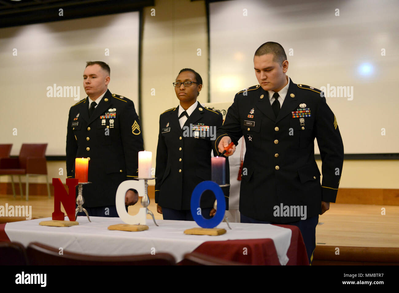 Sgt. Joseph Garza, a physical therapy specialist, lights a candle