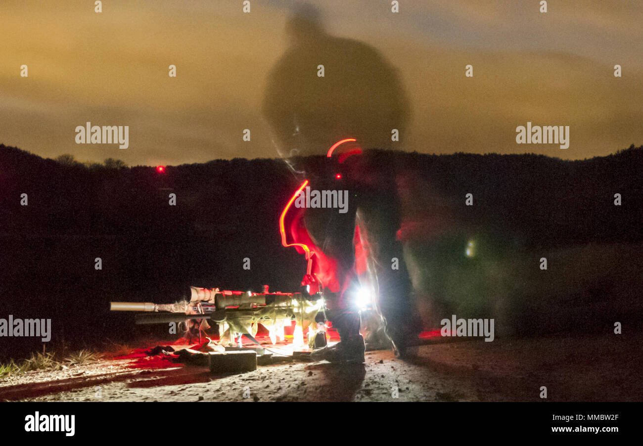 A two-man sniper team prepares for a nighttime test on the range during the Basic Sniper Course, conducted by the International Special Training Centre at the Joint Multinational Readiness Center in Hohenfels, Germany, October 25, 2017. The ISTC is a multinational education and training facility which provides advanced and specialized training at the tactical level for Special Operations Forces and similar units from the Memorandum of Understanding, NATO and Partnership for Peace nations. (SOCEUR Stock Photo