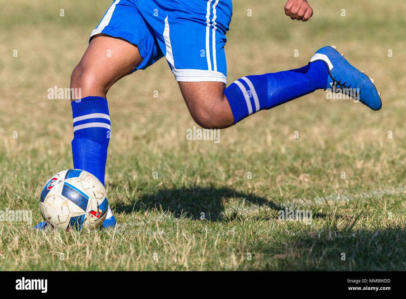 Asian football soccer player on playing field kicking ball kicking ball  closeup unidentified abstract Stock Photo - Alamy