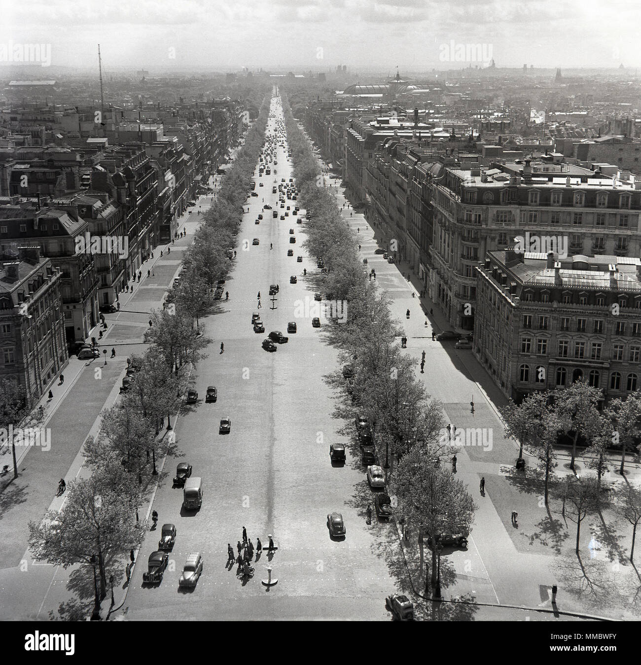 1950s, historical. overhead view down the wide tree-lined boulevard, the Avenue des Champs-Elysees, Paris, France, one of the most grand and beautiful avenues in the world, nearly 2 kilometres in length, and which connects the Arc de Triomphe to the Place de la Concorde. Stock Photo