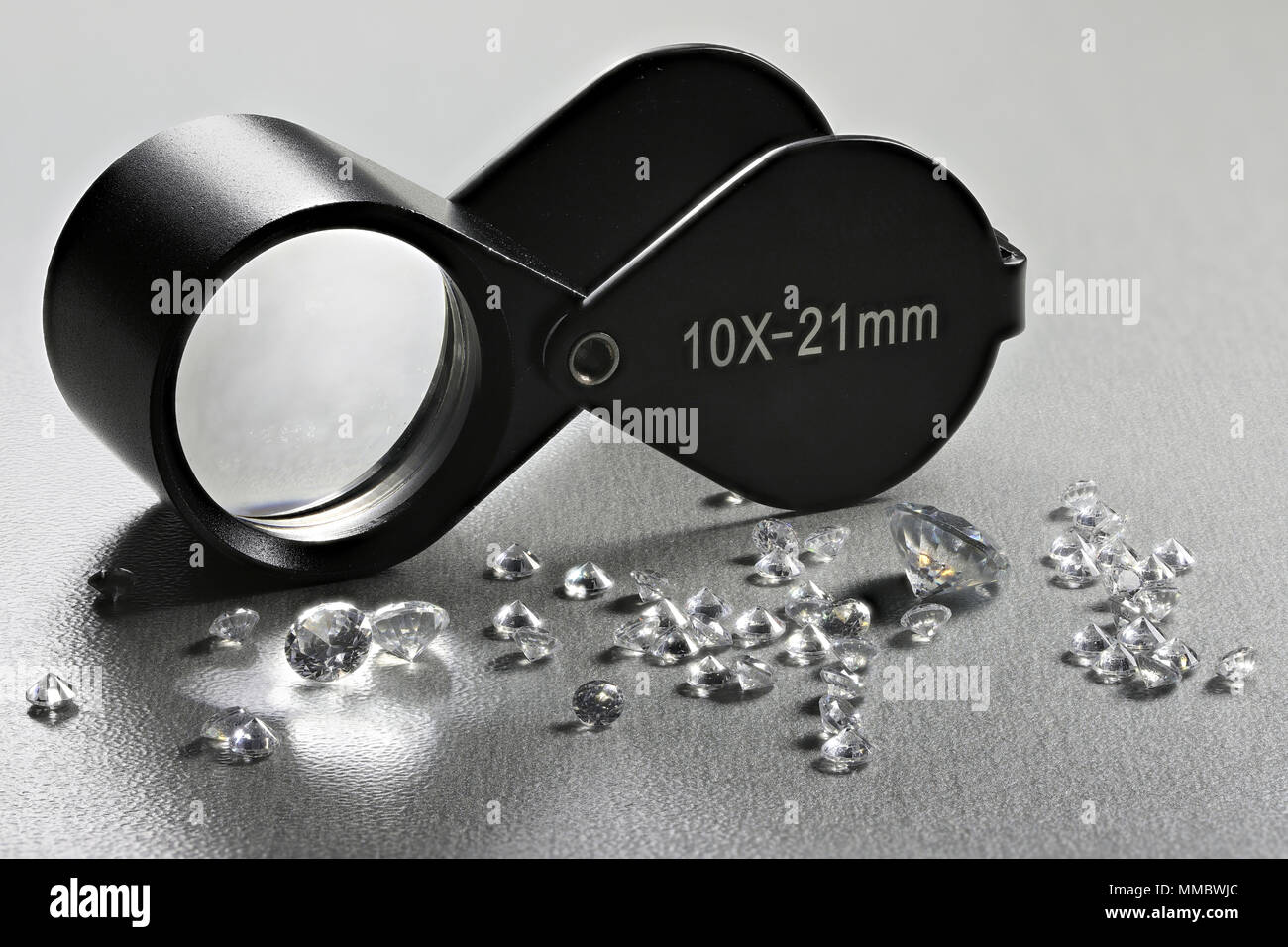 brilliant cut diamonds with folding magnifier Stock Photo