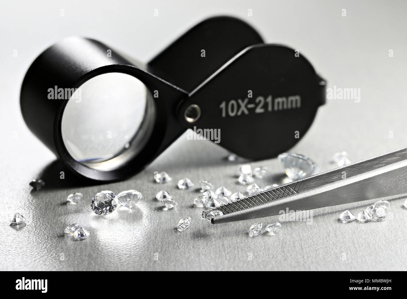 brilliant cut diamonds with folding magnifier Stock Photo