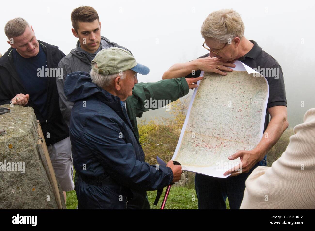 Elio Pasquale, an 83 year-old Italian local who remembered WWII and wears a 10th Mountain Division hat everywhere he goes, points out fighting positions on a map of the area at Mount Belvedere, Italy, on October 1. The group was on a tour that retraced the history of their Division by visiting WWII battlefields and signifcant sites to gain a deeper understanding, appreciation, and connection to the Division. (U.S. Army photo by Spc. Thomas Scaggs) 171001-A-TZ475-033 Stock Photo