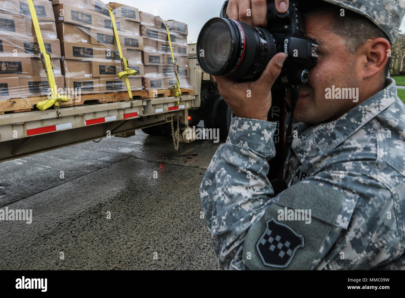 U.S. Army Reserve soldier, Sgt. Edgar Valdez, 220th Public Affairs Detachment, takes photos during a food delivery mission, that is part of Hurricane Maria relief efforts, outside of San Juan, Puerto Rico on Oct. 6, 2017. Valdez is part of a public affairs team that has spent the past several days working with Army Reserve soldiers, under the guidance and request of civil authorities, who are providing much needed supplies and resources to all of Puerto Rico. We're working hard to do our part to keep America informed. (U.S. Army Reserve photo by Staff Sgt. Felix R. Fimbres) Stock Photo