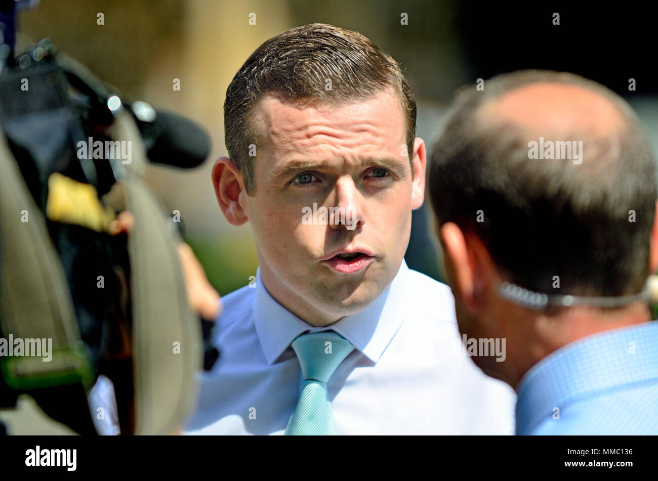 Douglas Ross MP (Conservative: Moray) being interviewed on College Green, Westminster by BBC's Norman Smith. Stock Photo
