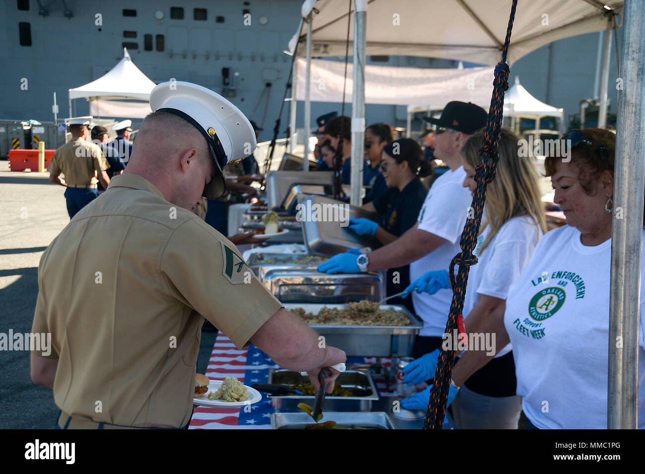 SAN FRANCISCO (Oct. 8, 2017) Volunteers from Oakland Navy League, Oakland Police Department and local civic organizations serve lunch to Sailors, Marines and Coast Guardsmen as part of Fleet Week San Francisco 2017. Fleet week provides an opportunity for the American public to meet their Navy, Marine Corps, and Coast Guard team and to experience America’s sea services. Fleet Week San Francisco will highlight naval personnel, equipment, technology, and capabilities, with an emphasis on humanitarian assistance and disaster response. (U.S. Navy photo by Mass Communication Specialist 1st Class Ant Stock Photo