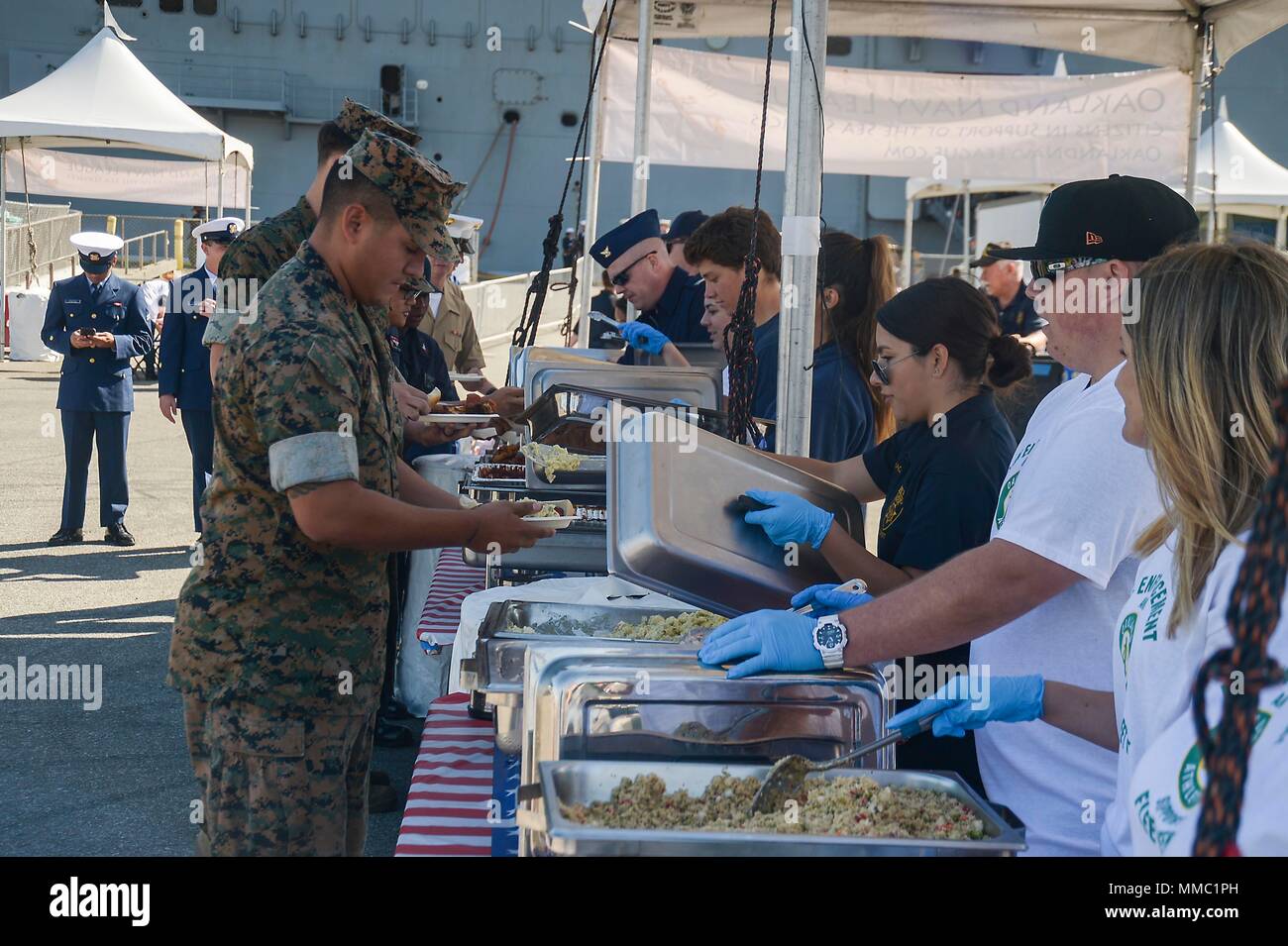 SAN FRANCISCO (Oct. 8, 2017) Volunteers from Oakland Navy League, Oakland Police Department and local civic organizations serve lunch to Sailors, Marines and Coast Guard members during Fleet Week San Francisco 2017. Fleet week provides an opportunity for the American public to meet their Navy, Marine Corps, and Coast Guard team and to experience America’s sea services. Fleet Week San Francisco will highlight naval personnel, equipment, technology, and capabilities, with an emphasis on humanitarian assistance and disaster response. (U.S. Navy photo by Mass Communication Specialist 1st Class Ant Stock Photo