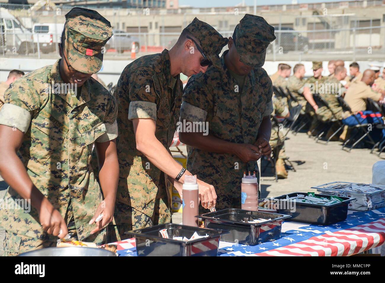 SAN FRANCISCO (Oct. 8, 2017) Marines prepare plates at a barbecue hosted by the Oakland Navy League, Oakland Police Department and local civic organizations during Fleet Week San Francisco 2017. Fleet week provides an opportunity for the American public to meet their Navy, Marine Corps, and Coast Guard team and to experience America’s sea services. Fleet Week San Francisco will highlight naval personnel, equipment, technology, and capabilities, with an emphasis on humanitarian assistance and disaster response. (U.S. Navy photo by Mass Communication Specialist 1st Class Anthony Walker) Stock Photo