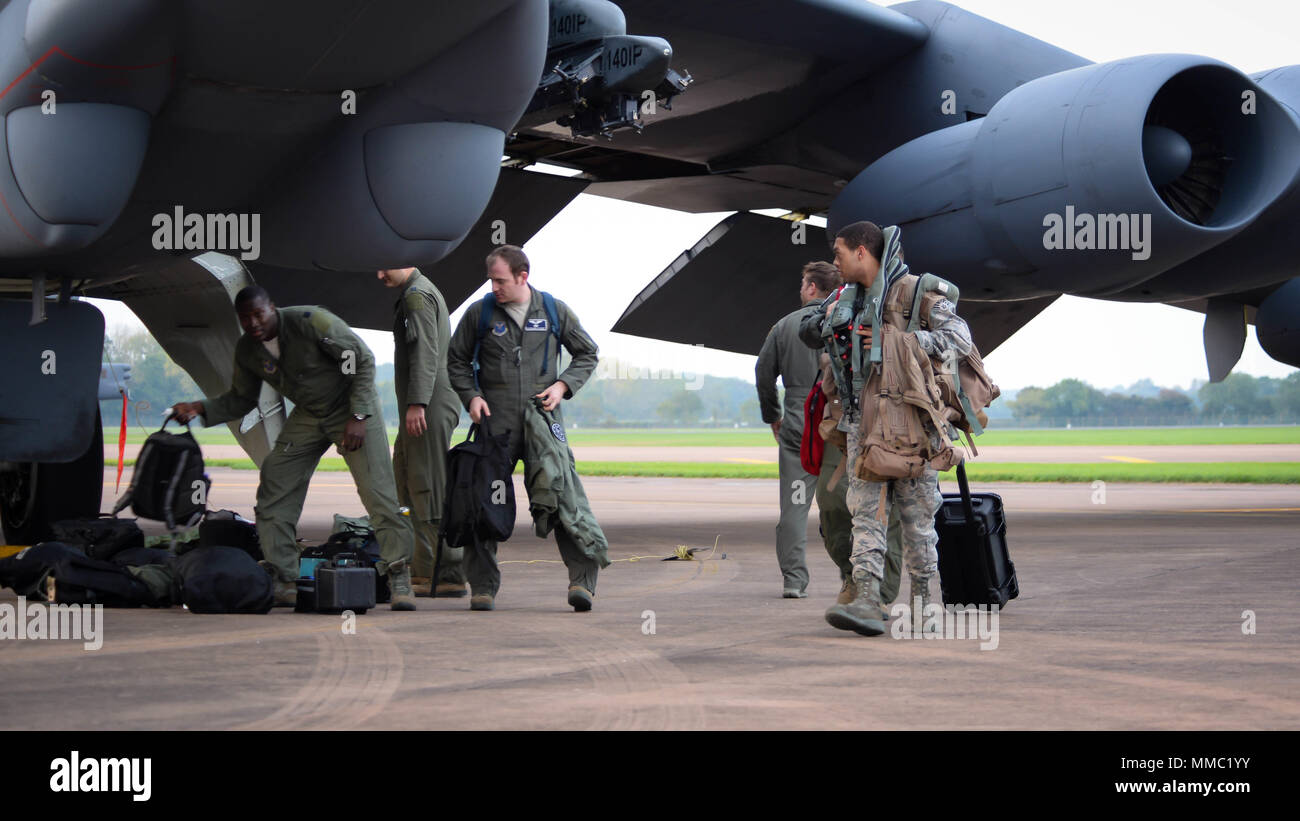 Aircrew retrieve their gear from a B-52 Stratofortress on RAF Fairford, United Kingdom, Sept. 26, 2017. The deployment of strategic bombers to the United Kingdom helps exercise RAF Fairford as U.S. Air Forces in Europe’s forward operating location for bombers. The deployment will also include joint and allied training to improve bomber interoperability. Training with joint partners, allied nations and other U.S. Air Force units contributes to our ready and postured forces and enables us to build enduring and strategic relationships necessary to confront a broad range of global challenges. (U.S Stock Photo