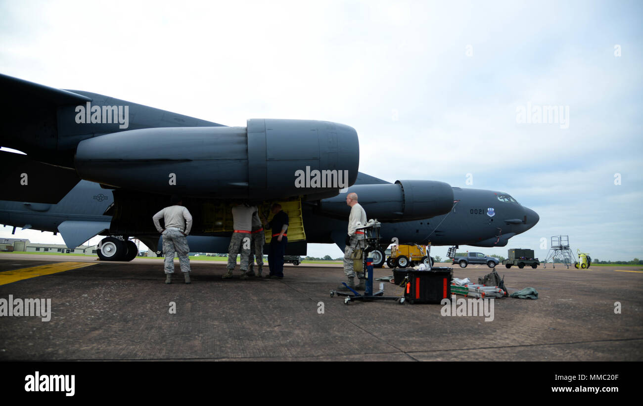 Airmen from the 96th Aircraft Maintenance Unit change a drive generator on a B-52 Stratofortress at Fairford Royal Air Force Base, U.K., Sept. 20, 2017. Drive generators must be changed if they overheat during a flight. The change takes around six hours to complete and will ensure continued power for B-52 electrical systems. (U.S. Air Force photo/Staff Sgt. Benjamin Raughton) Stock Photo