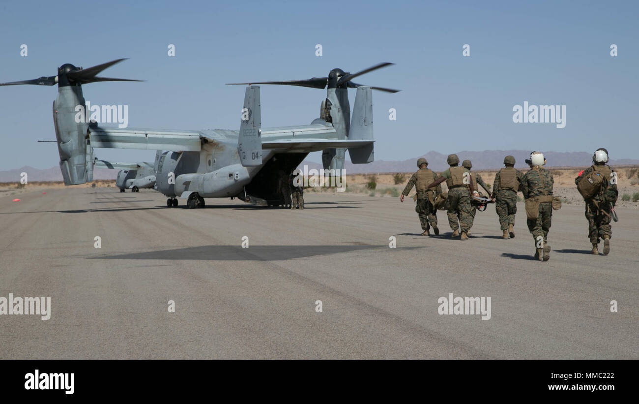 U.S. Sailors from 1st Medical Battalion, Surgical Company Bravo, 1st Marine Logistics Group, carry a simulated shock trauma victim during Weapons and Tactics Instructors Course (WTI) 1-18 at Yuma, Ariz., on Oct. 9, 2017. WTI is a seven week training event hosted by Marine Aviation and Weapons Tactics Squadron One (MAWTS-1) cadre which emphasizes operational integration of the six functions of Marine Corps Aviation in support of a Marine Air Ground Task Force. MAWTS-1 provides standardized advanced tactical training and certification of unit instructor qualifications to support Marine Aviation  Stock Photo