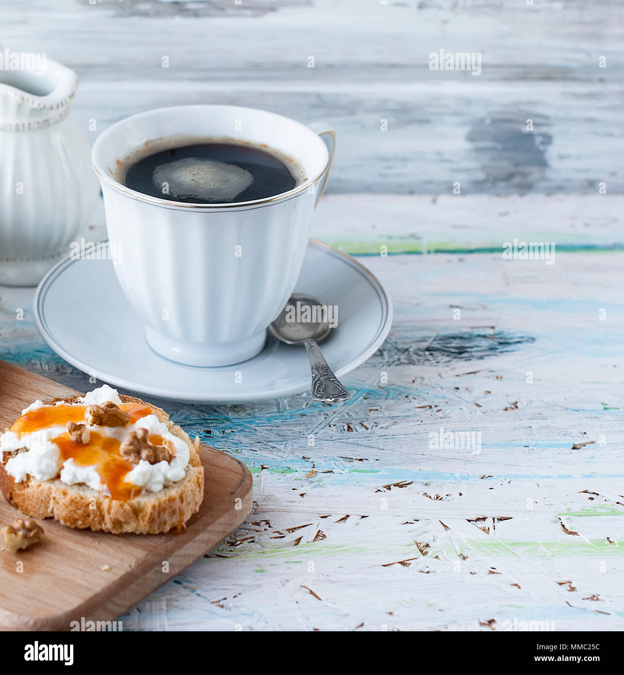 sandwiches with ricotta, honey, nuts and coffee with cream milk for