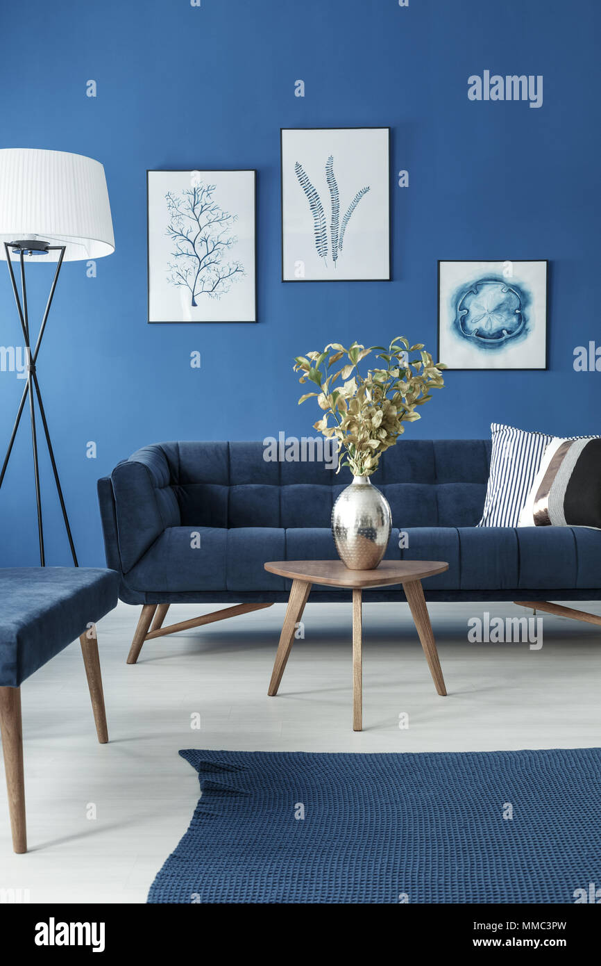 Blue and white living room with sofa and small wooden coffee table Stock  Photo - Alamy