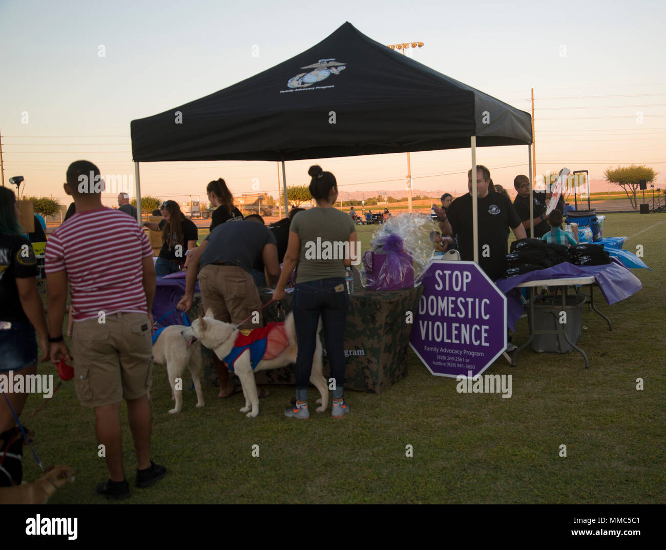 U.S. Marines, Sailors, and families attend Purple Paws for a Cause at Meyers Park on Marine Corps Air Station Yuma, Ariz., Oct. 6, 2017. Paws for a Cause is an event hosted by the Family Advocacy Program, that raises awareness of domestic violence and animal abuse. (U.S. Marine Corps photo by Lance Cpl. Sabrina Candiaflores) Stock Photo