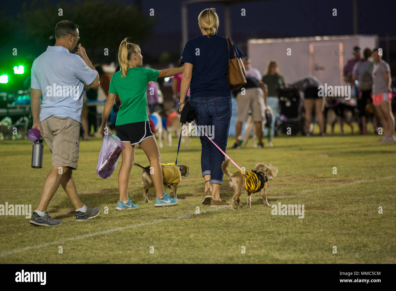 U.S. Marines, Sailors, and families attend Purple Paws for a Cause at Meyers Park on Marine Corps Air Station Yuma, Ariz., Oct. 6, 2017. Purple Paws for a Cause is an event hosted by the Family Advocacy Program that raises awareness of domestic violence and animal abuse. (U.S. Marine Corps photo by Lance Cpl. Sabrina Candiaflores) Stock Photo