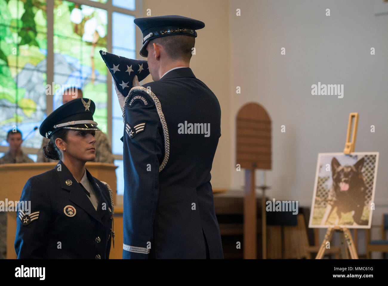 The base honor guard performs a flag folding ceremony in honor of Meki