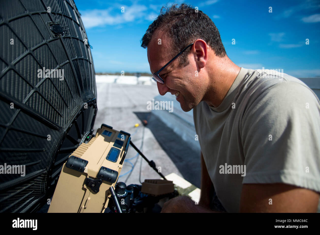 U.S. Air Force Staff Sgt. Robert Lonack, cyber transport systems technician, 1st Combat Camera Squadron, calibrates a Defense Video Imagery Data System (DVIDS) satellite dish, allowing the 156th Airlift Wing Public Affairs to transmit imagery of Hurricane Maria relief efforts at  Muniz Air National Guard Base, Puerto Rico, Oct. 6, 2017. The DVIDS satellite dish is critical in locations where there is no internet. (U.S. Air Force photo by Airman 1st Class Nicholas Dutton) Stock Photo