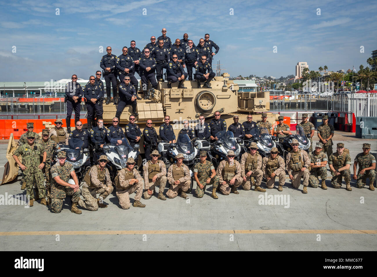 Marines along with the San Diego Police Department pose for a group picture at the Broadway Pier in San Diego, Calif., Oct. 11, 2017 as part of San Diego Fleet Week. Fleet week provides an opportunity for the American public to meet their Marine Corps, Navy and Coast Guard team and experience America's sea services. (U.S. Marine Corps photo by Lance Cpl. Gabino Perez) Stock Photo