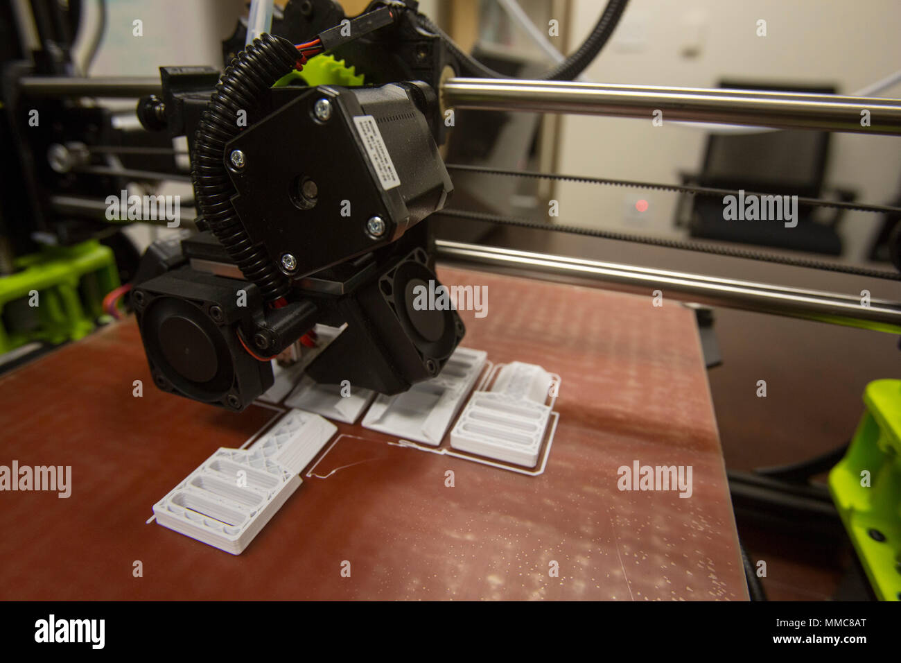The 3-D printer and the finished layout of pack clips from 2nd Battalion, 8th Marine Regiment at Camp Lejeune, N.C., Oct. 6, 2017. 2/8 is the first infantry battalion in the United States Marine Corps to utilize a 3-D printer to ensure battalion readiness in the event of equipment malfunctions. (U.S. Marine Corps photo by Lance Cpl. Ashley McLaughlin) Stock Photo