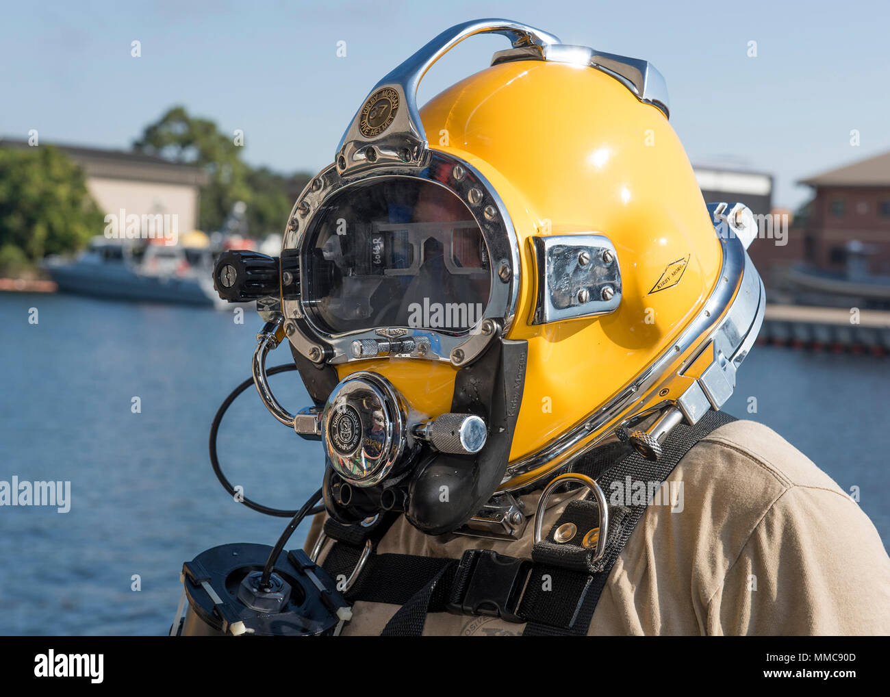 Naval Surface Warfare Center Panama City Division Commanding Officer Capt. Aaron Peters, USN, conducts pre-dive checks with the KM-37 dive helmet fitted with a heads-up display prototype called the Diver Augmented Vision Display, or DAVD, Oct. 12, 2017. The prototype offers situational awareness in low visibility environments. The successful DAVD phase II, in-water testing was conducted Oct. 10-13, 2017 in Panama City, Florida at Naval Diving Salvage Training Center by NSWC PCD scientists and engineers. U.S. Navy photo by Ron Newsome, NSWC PCD. Stock Photo