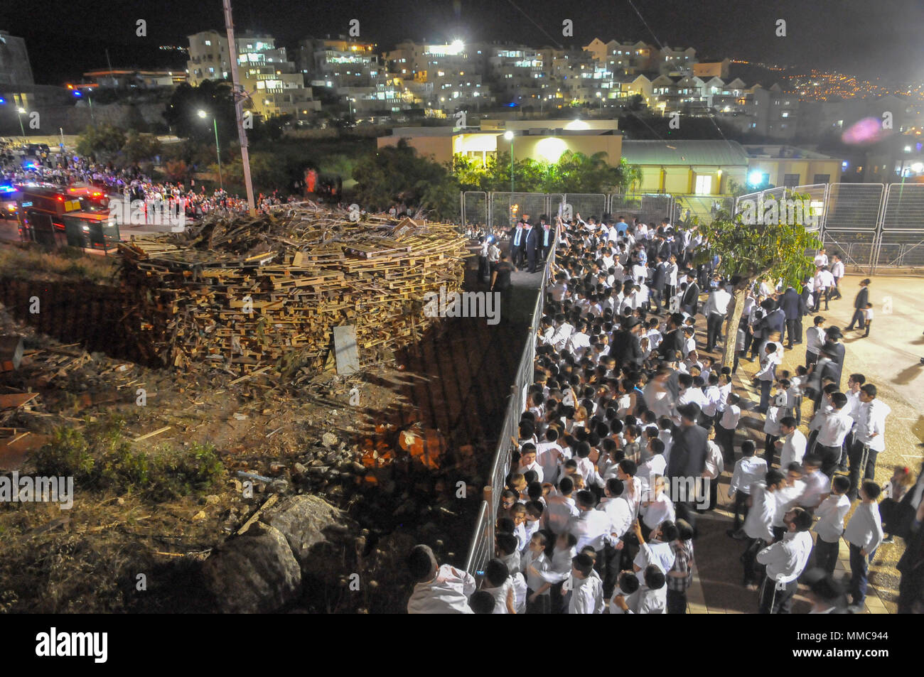 The lightning of the main fire at the Hillula (a celebration day) for Rabbi Simeon bar Yohai at Lag Baomer in Meron mountain, near Tzefat, the burial place of Rabbi Simeon bar Yochai and his son, Rabbi Eleazar ben Simon. hundred of thousands of people come each year to celebrate with lighting fires, candles, singing and feasting.  Photographed on May 2 2018 Stock Photo