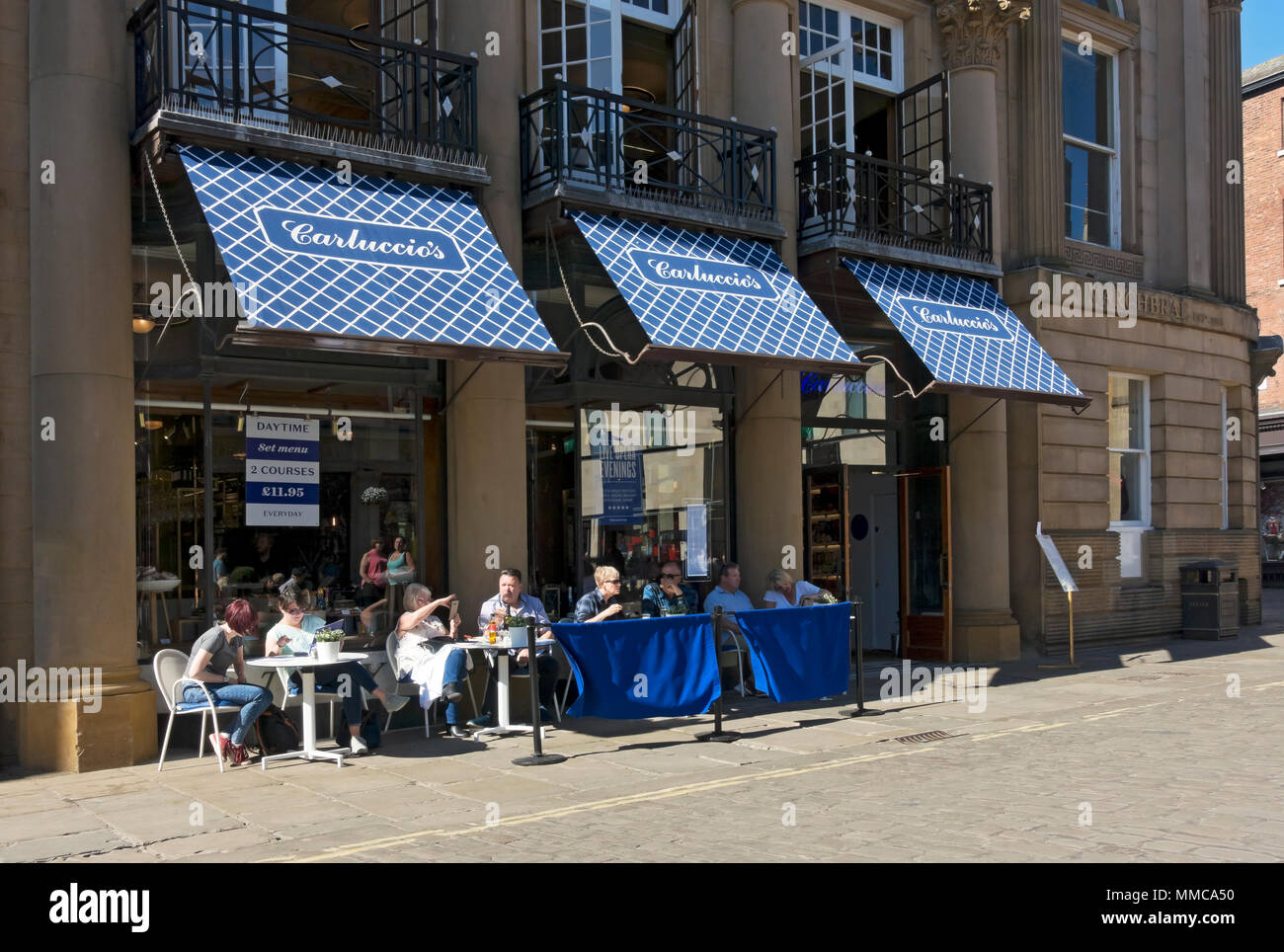 People sitting dining outside Carluccio's restaurant in spring St Helens Square York North Yorkshire England UK United Kingdom GB Great Britain Stock Photo