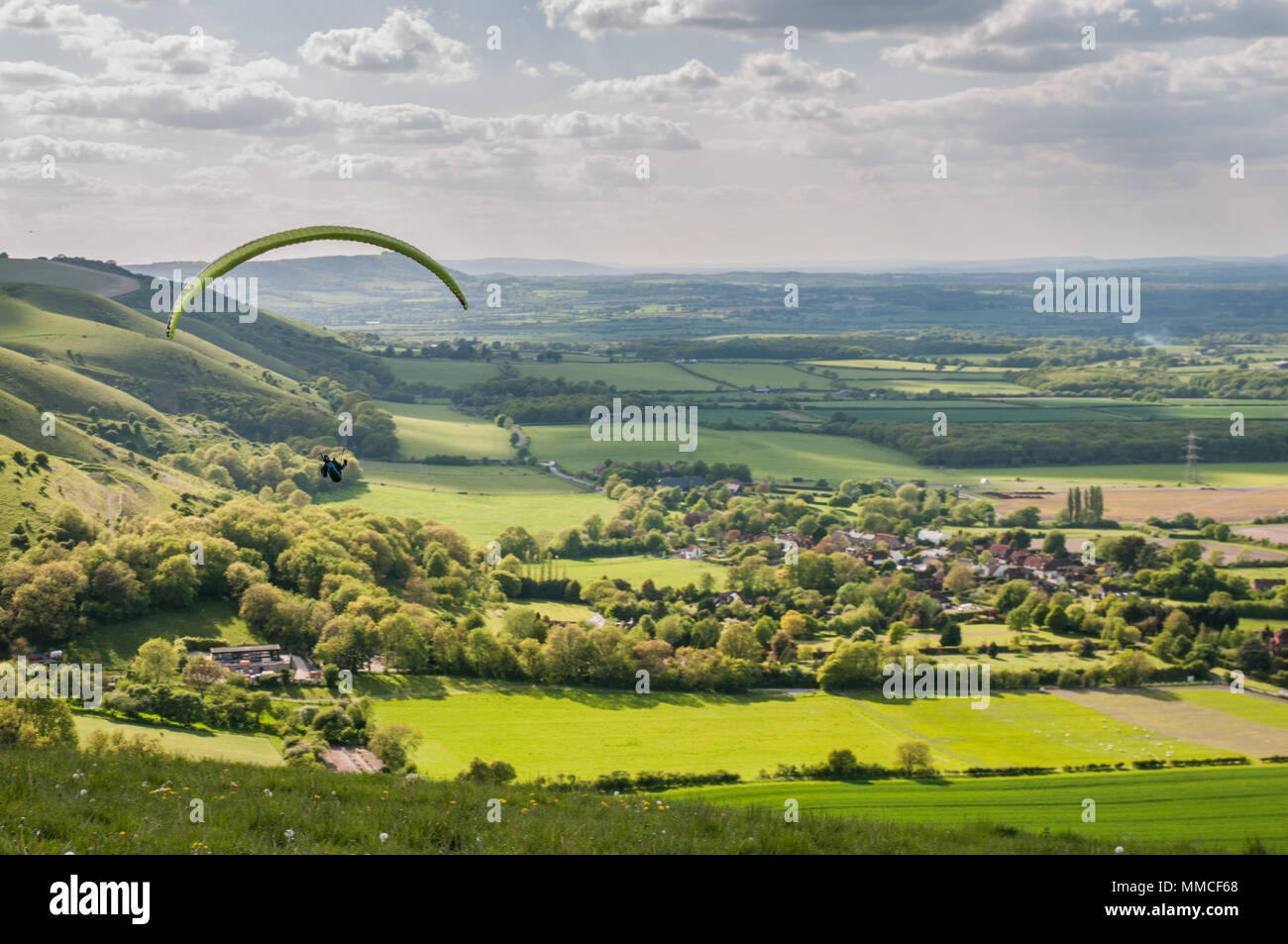 Brighton, Sussex, UK..10 May 2018..Cooler weather,  clouds & North Westerly wind brings Paraglider pilots to Devils Dyke on the South Downs Way. Stock Photo